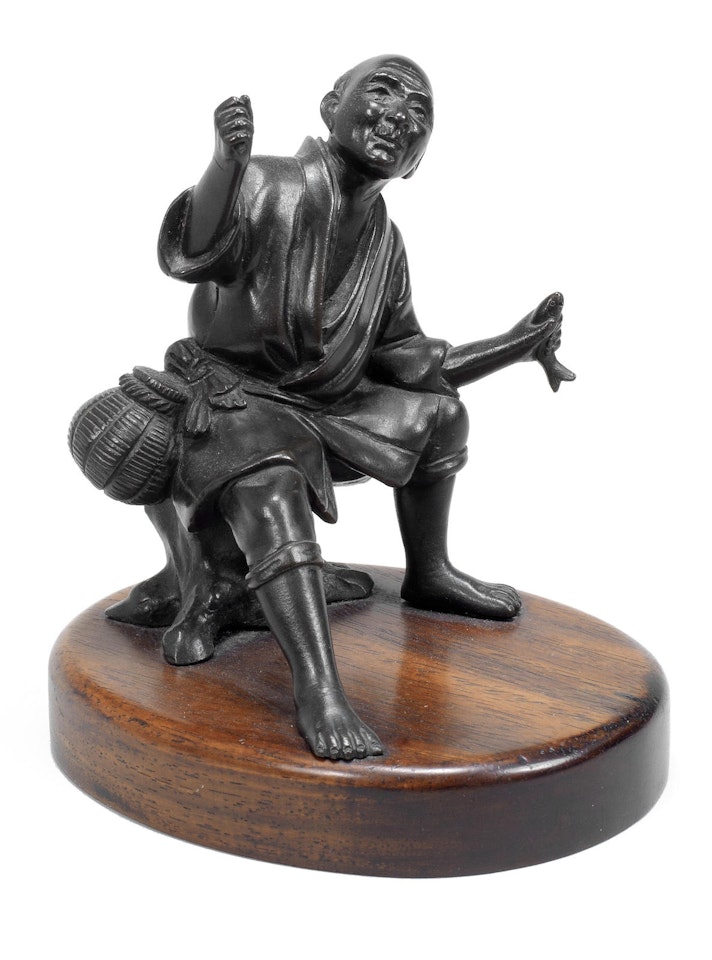 A bronze figure of a fisherman by Anonymous