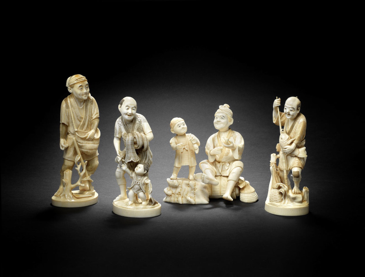 Three ivory okimono and one walrus-tusk okimono of fishermen by Anonymous