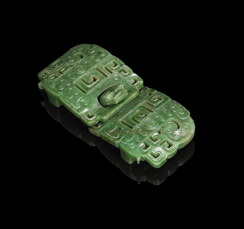 A spinach green jade reticulated belt buckle by Anonymous