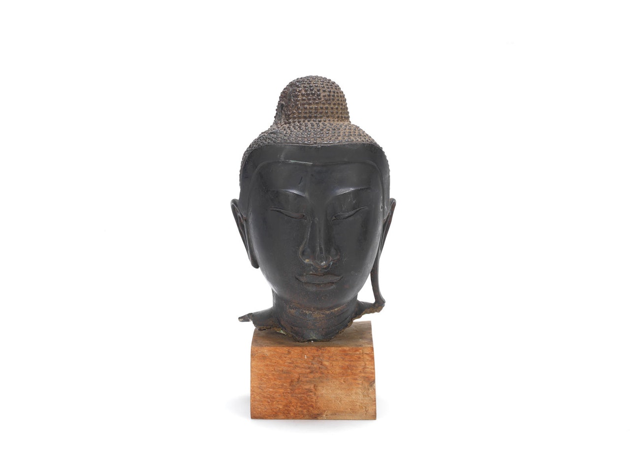 A large bronze head of Buddha by Anonymous