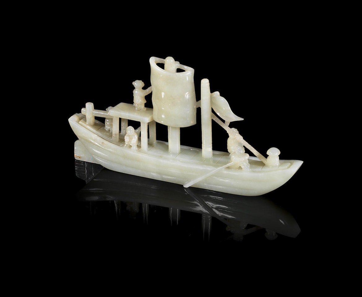 A pale green jade sailing boat with figures by Anonymous