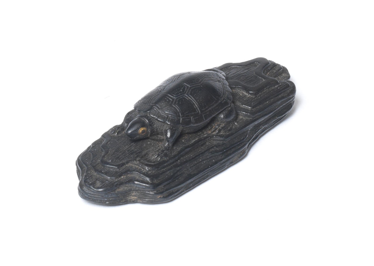 An ebony netsuke of a terrapin on a section of driftwood by Anonymous