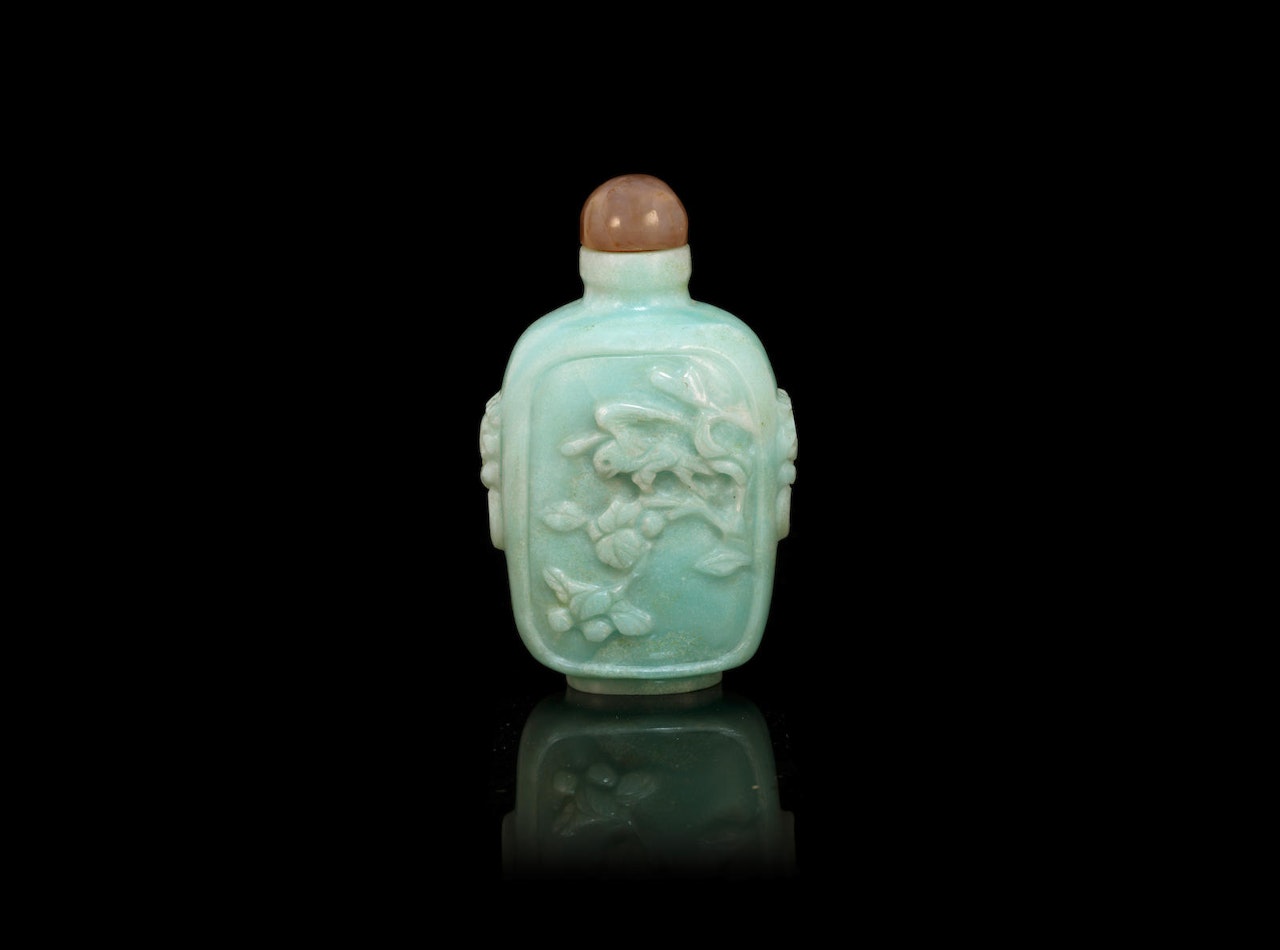 A carved jadeite 'bird and flower' snuff bottle by Anonymous