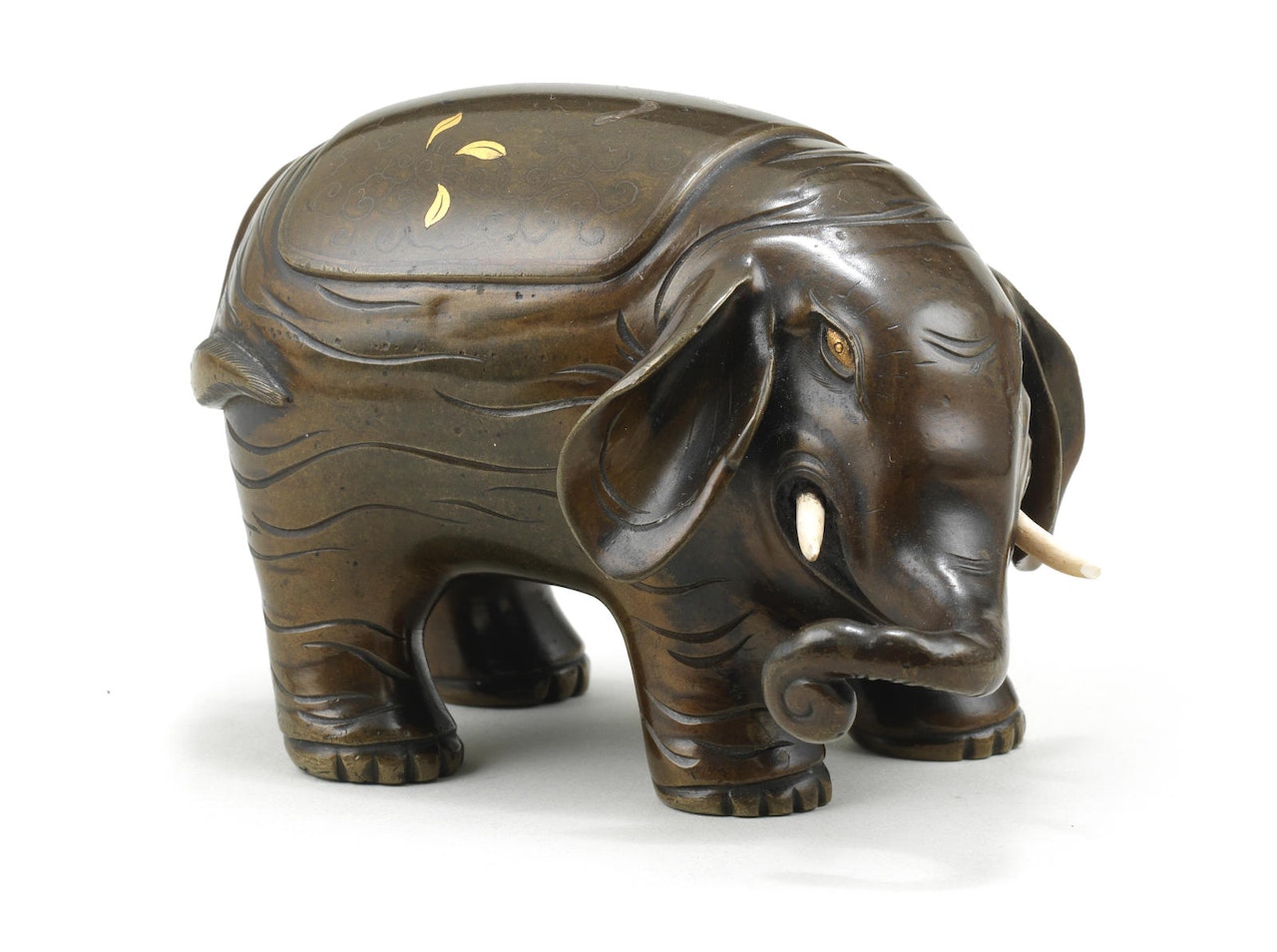 A partially inlaid bronze elephant by Anonymous