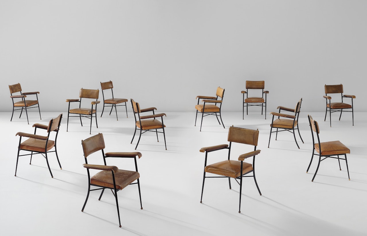 Set of twelve chairs by Jacques Adnet