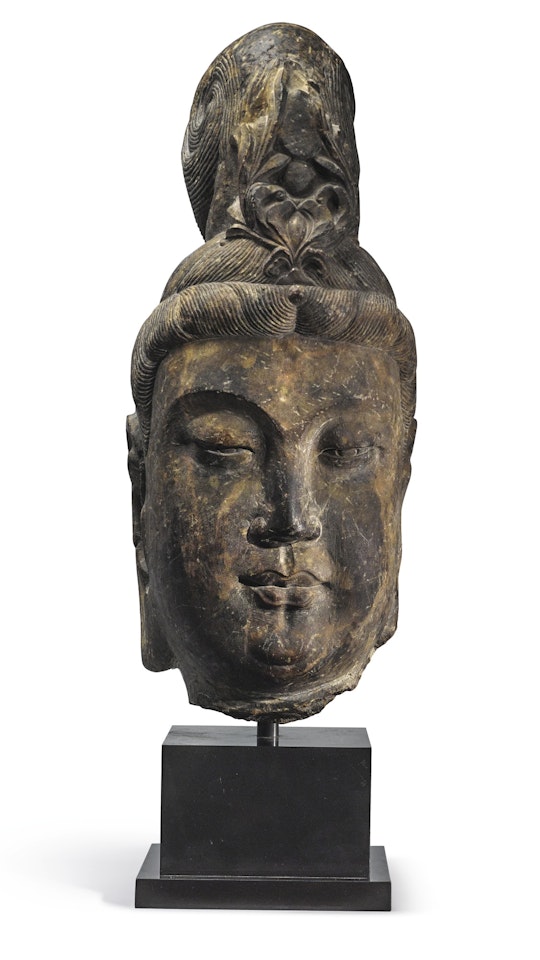 A LARGE STONE HEAD OF A BODHISATTVA by Anonymous