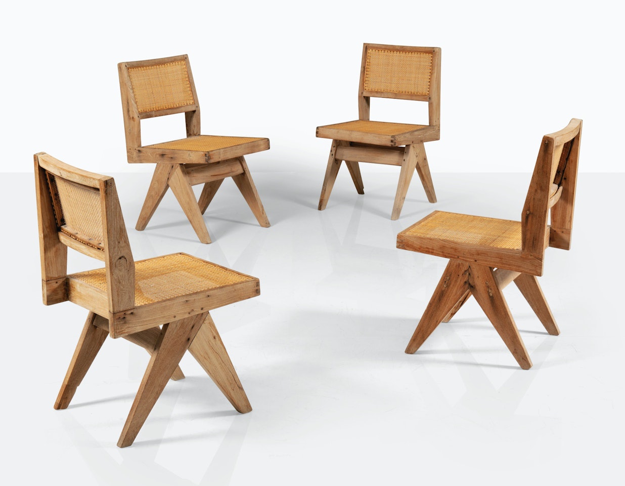 A SET OF FOUR CHAIRS PJ-SI-25-A by Pierre Jeanneret