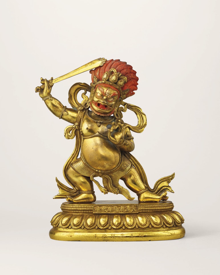 A GILT-BRONZE FIGURE OF DHARMAPALA AND A STAND by Anonymous