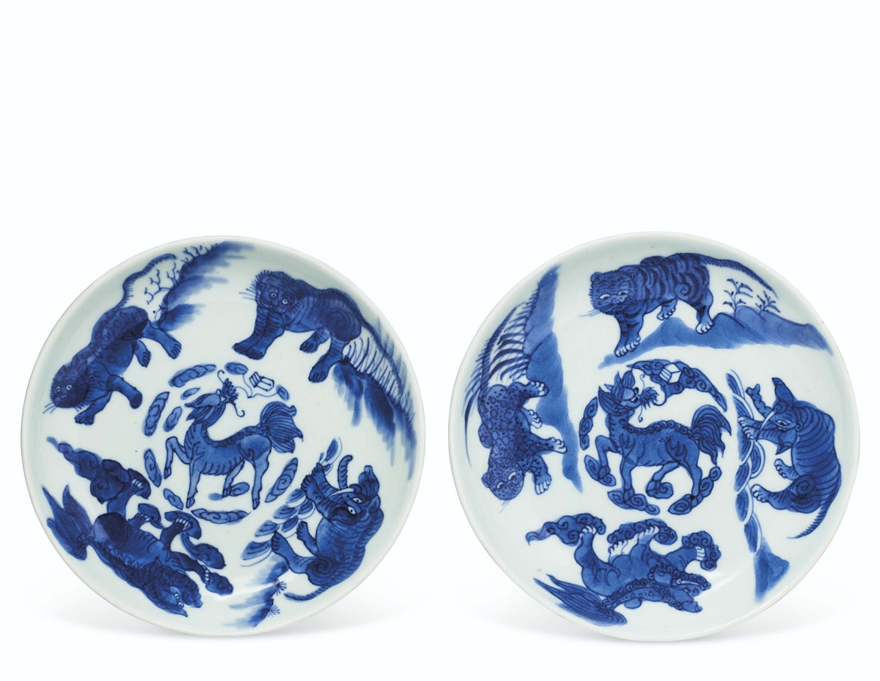 A PAIR OF BLUE AND WHITE 'MYTHICAL BEAST' DISHES by Anonymous