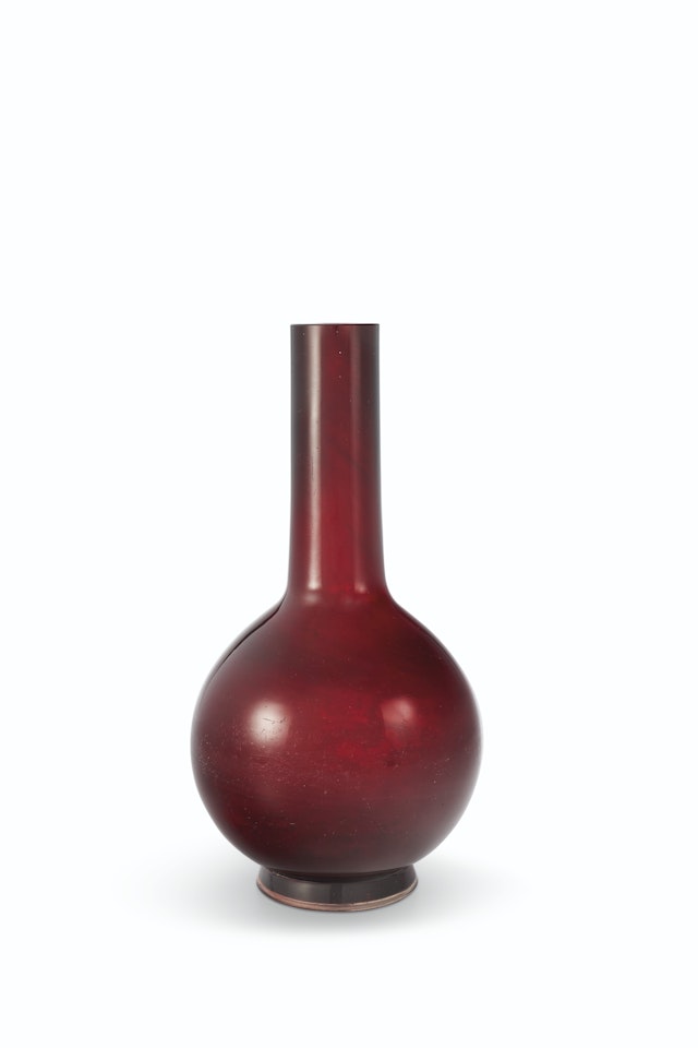 A TRANSLUCENT GARNET-RED GLASS BOTTLE VASE by Anonymous