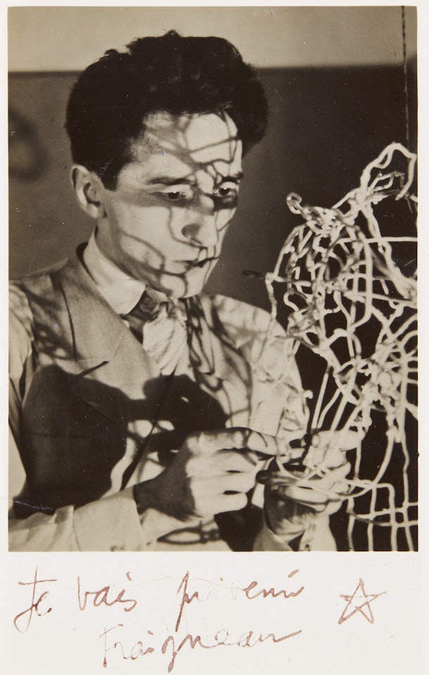 'JEAN COCTEAU WITH SELF-PORTRAIT WIRE STRUCTURE', CA.1925 by Man Ray