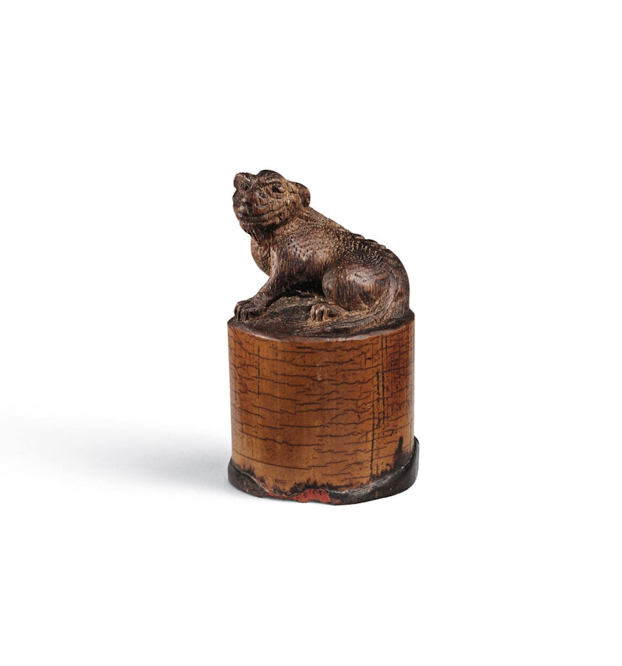 A CARVED BAMBOO ROOT ‘LION’ SEAL by Anonymous
