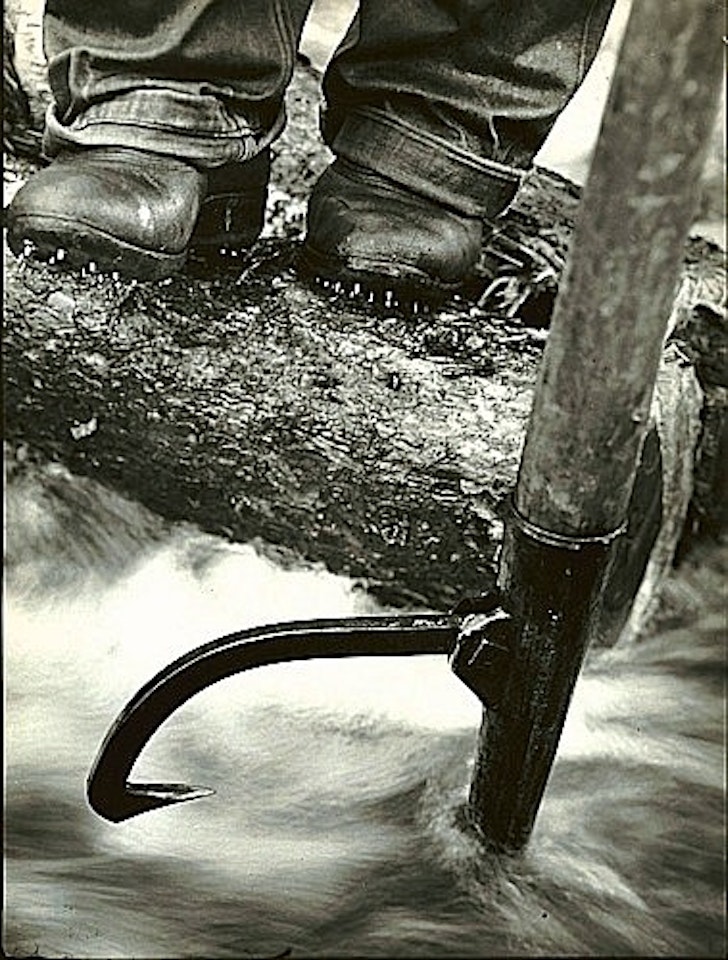 Close-up of log driver's feet while using a peavey by Margaret Bourke-White