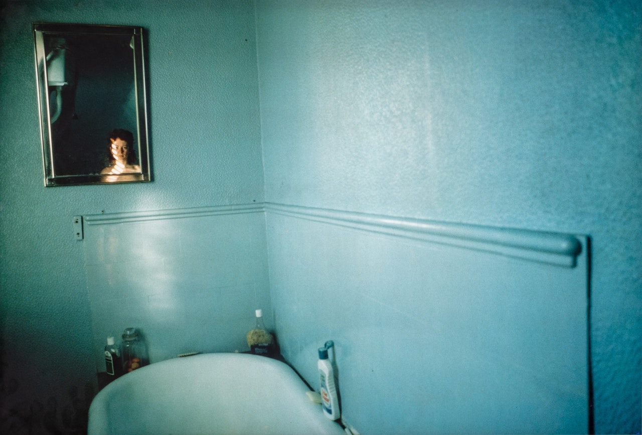 Self-Portrait in Blue Bathroom by Nan Goldin