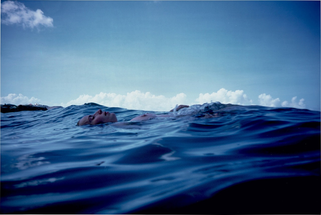 Christine floating in the waves, St. Barth's by Nan Goldin