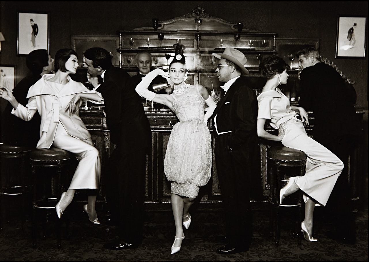 Audrey Hepburn and Art Buchwald with Simone, Barbara Mullen, Frederick Eberstadt and Dr. Reginald Kernan, Evening Dresses by Balmain, Dior, Patou, Maxim's, Paris, August by Richard Avedon