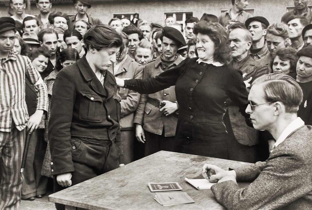 Gestapo informer recognized by a woman she had denounced, Transit Camp, Dessau, Germany by Henri Cartier-Bresson