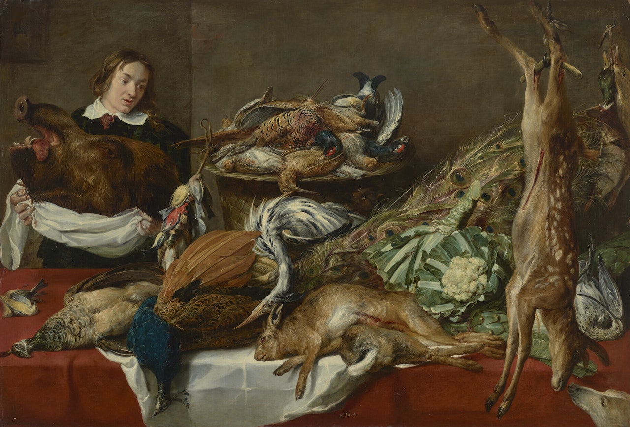 A boy in a pantry holding a boar's head, with pheasant, peacocks, quail, rabbits, a doe, other game, cauliflowers, and artichokes displayed on a table by Frans Snyders