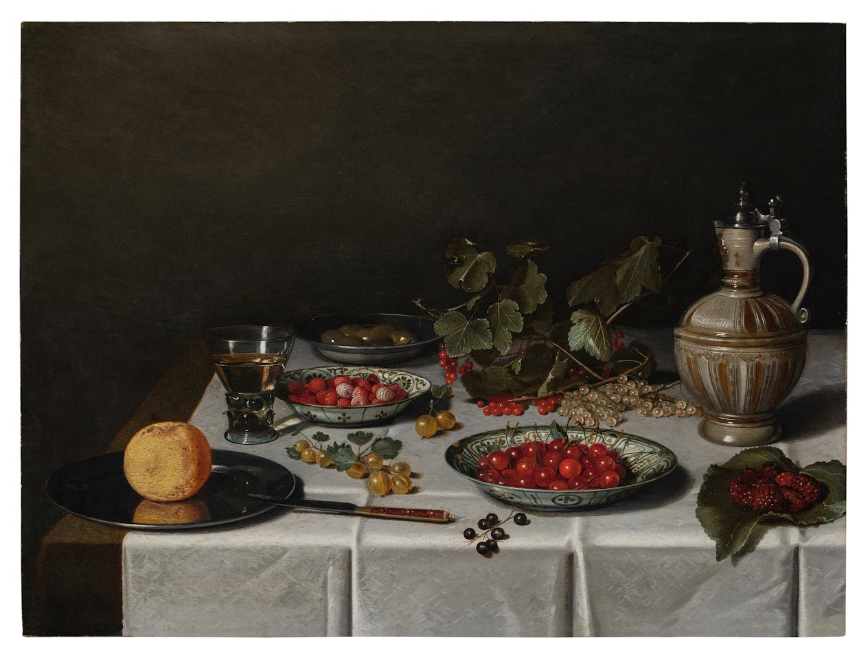 A Still Life with Cherries and Strawberries in Wanli Dishes, an Orange on a Pewter Plate with a Knife, Gooseberries, Red, White and Black Currants, Mulberries, a Berkemeier and a Stoneware Jug on a Table Covered with a White Tablecloth by Pieter Claesz