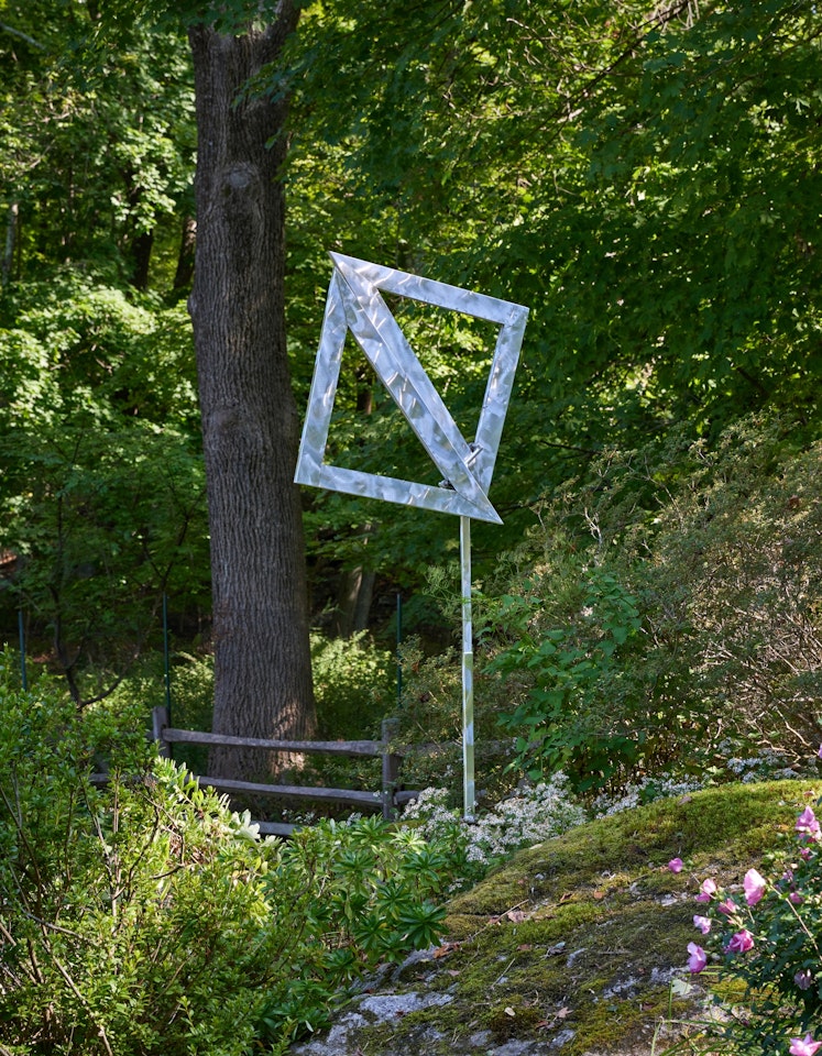 Two Open Triangles Leaning Gyratory II by George Rickey