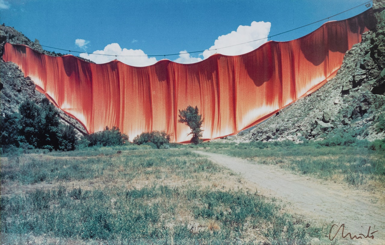 "Running Fence" and "Valley Curtain" are two of Christo and Jeanne-Claude's most renowned large-scale environmental art installations. Both projects exemplify their unique approach to art that involves wrapping and draping large structures and landscapes with fabric, transforming them into temporary works of art. by Christo