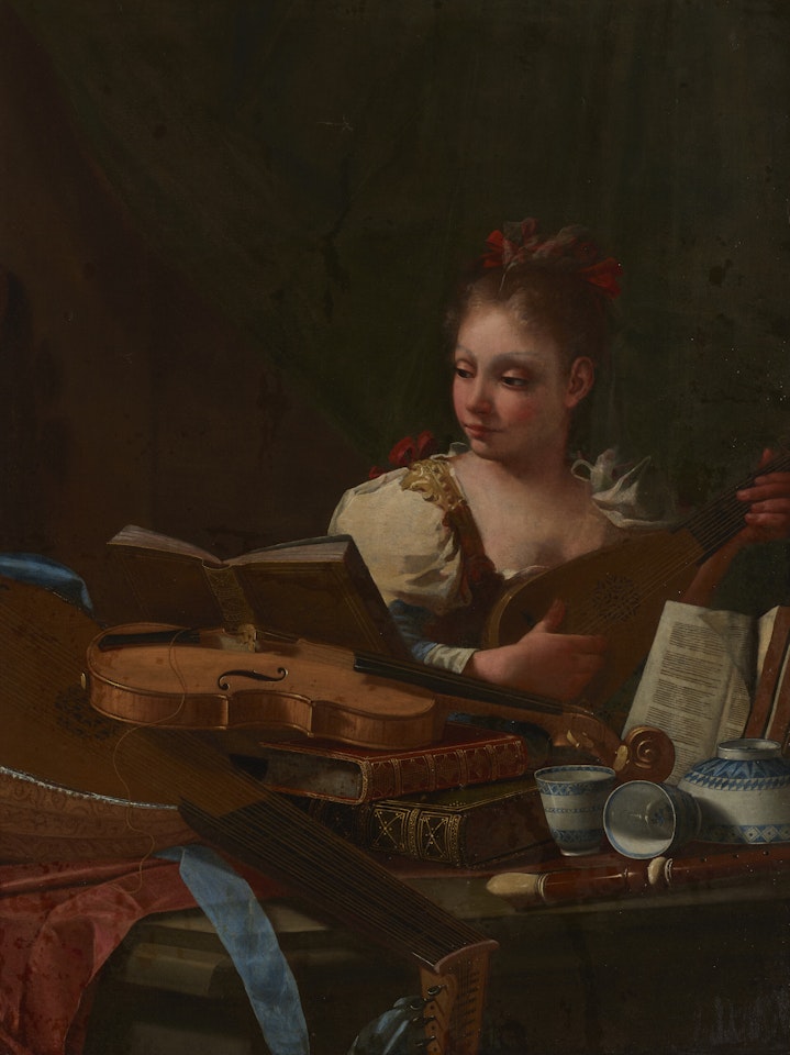 A girl playing a mandolin, with a lute, a viol, books and blue and white porcelain on a table by Cristoforo Munari