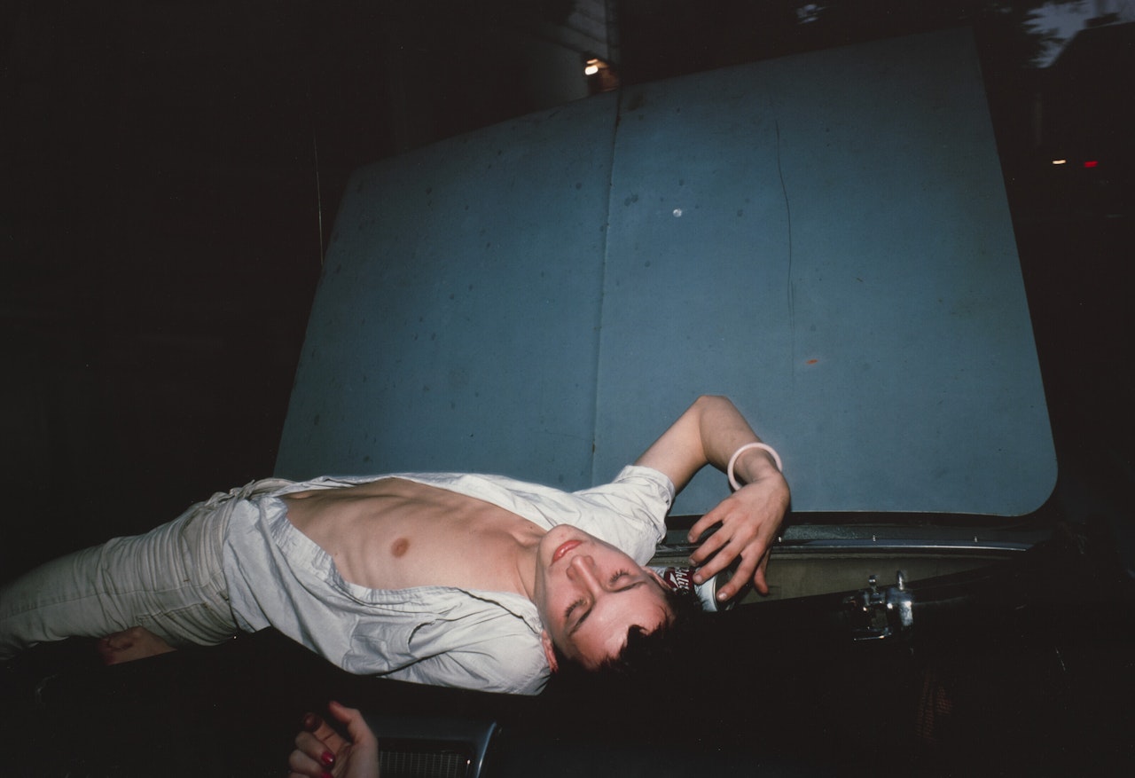 French Chris on convertible, NYC by Nan Goldin