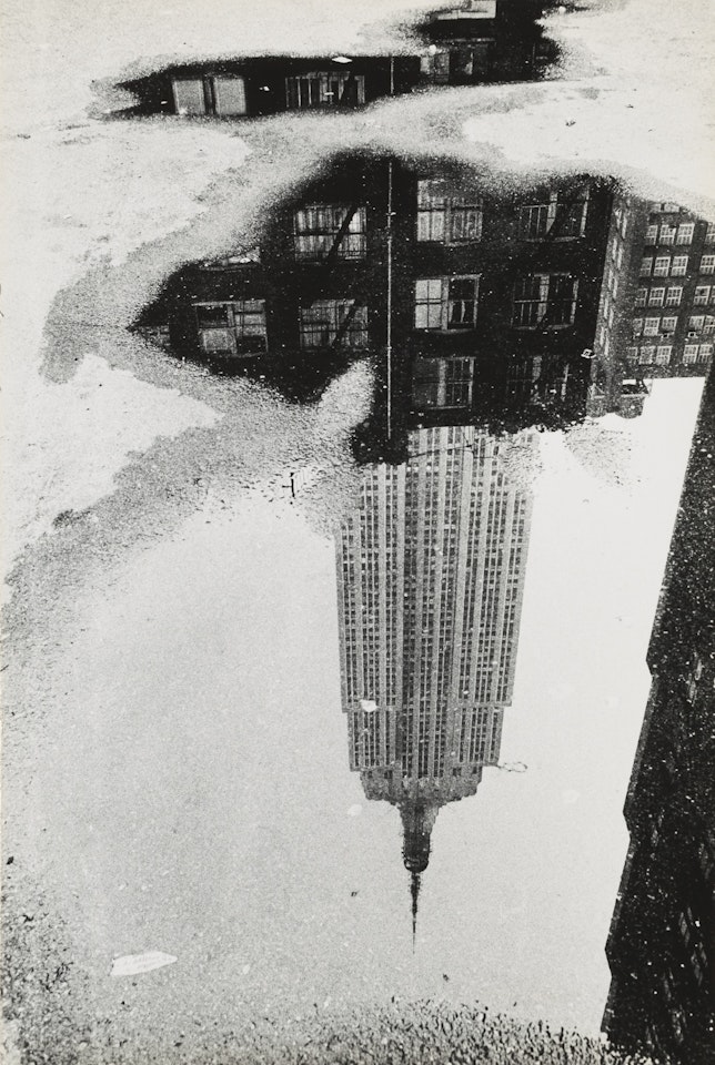 NEW YORK (EMPIRE STATE BUILDING IN PUDDLE) by André Kertész