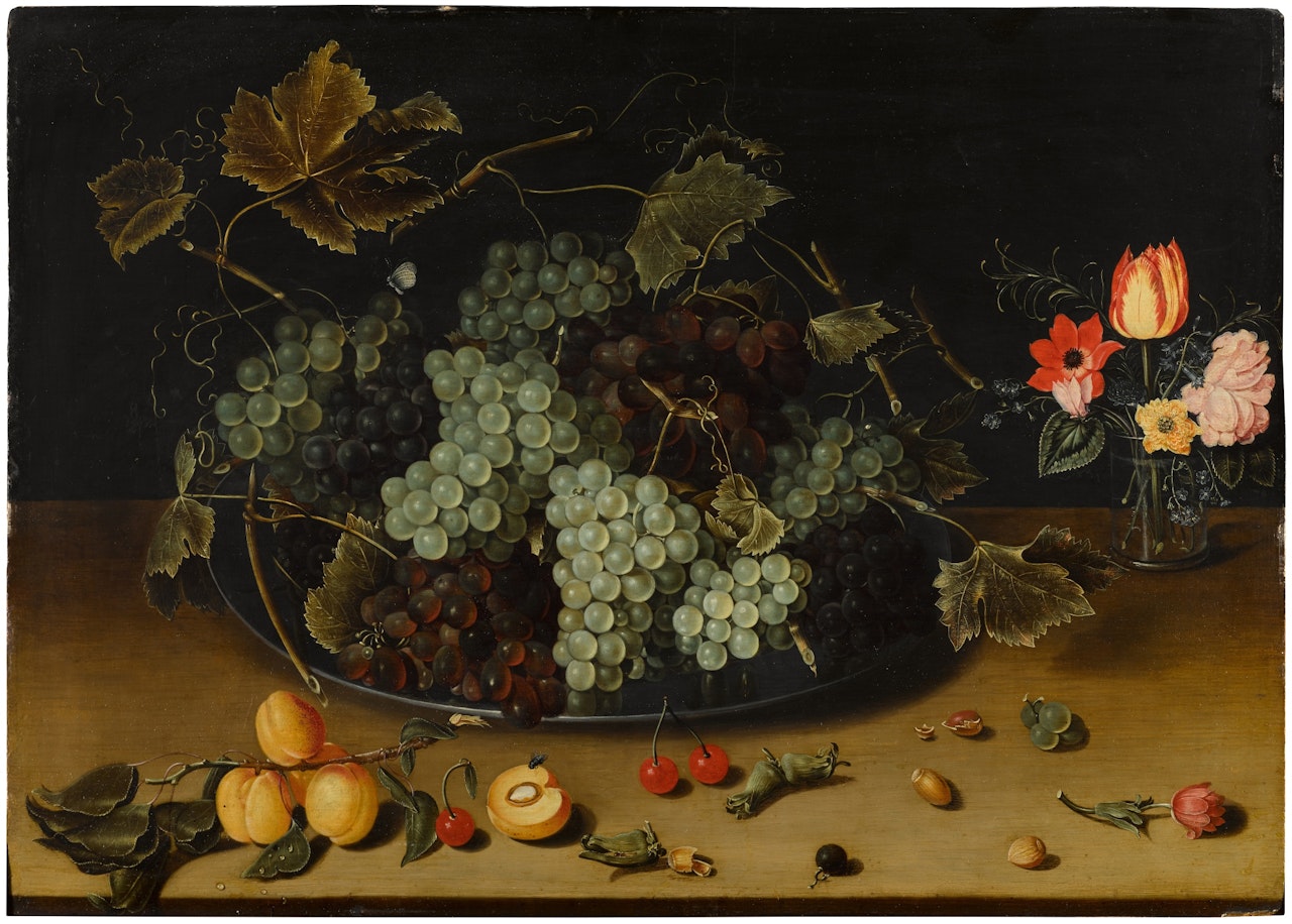 Still life with grapes on a pewter dish, a vase of flowers and other fruits by Isaak Soreau