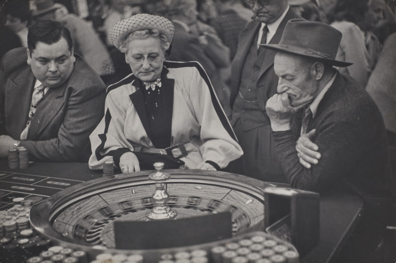 Las Vegas (3 people at gambling wheel) by Henri Cartier-Bresson