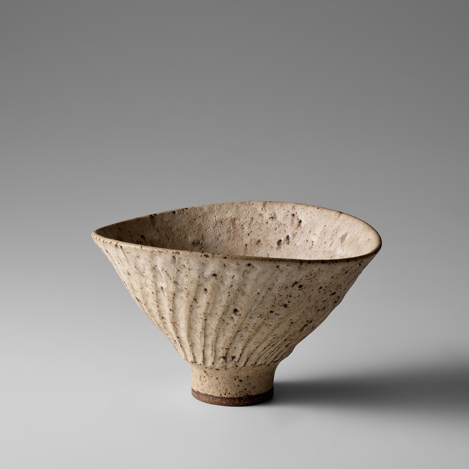 Deep oval bowl with fluted exterior by Lucie Rie