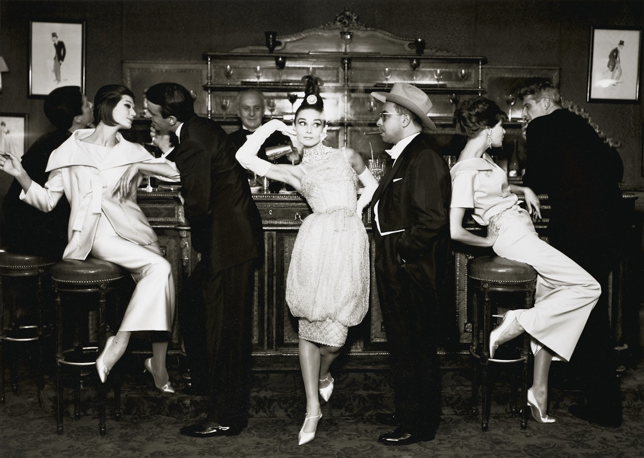 Audrey Hepburn and Art Buchwald with Simone, Barbara Mullen, Frederick Eberstadt, and Dr. Reginald Kernan, Evening dresses by Balmain, Dior, Patou, Maxim’s, Paris, August by Richard Avedon