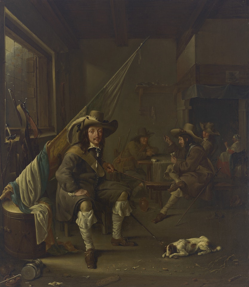 An Ensign seated in a guardroom, with officers playing at cards and a woman smoking by a chimney by Jacob Duck
