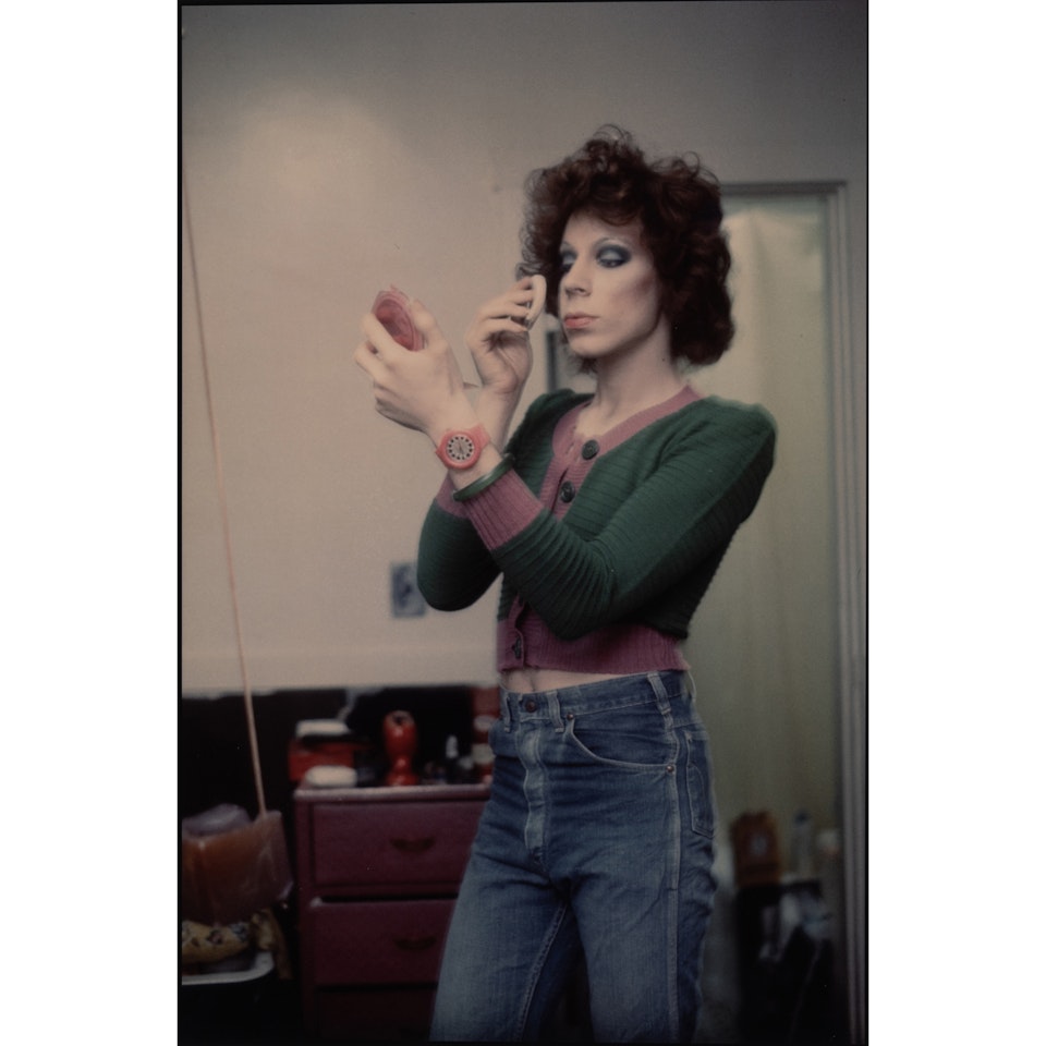 Kenny putting on makeup, Boston by Nan Goldin