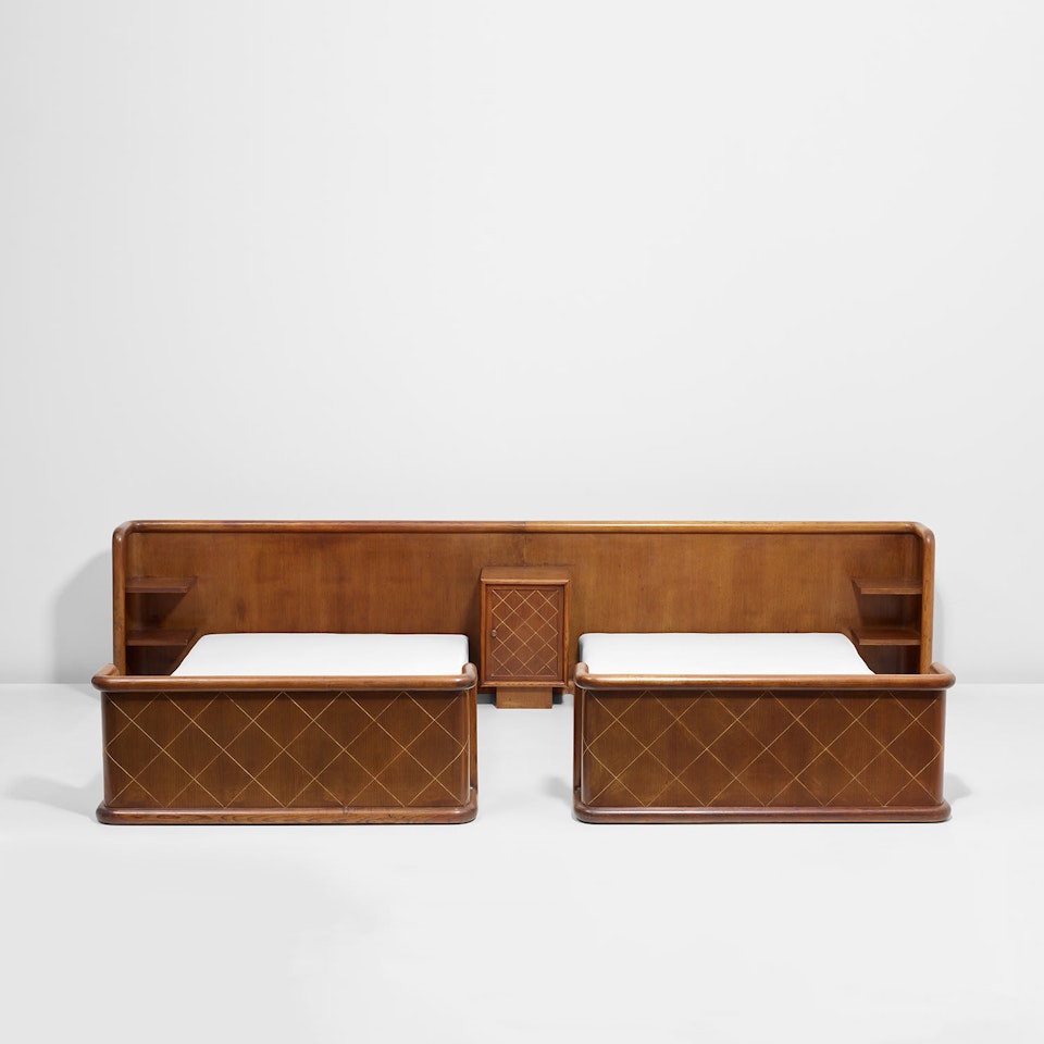 Two beds with integrated headboard and bedside table by Jean Royere