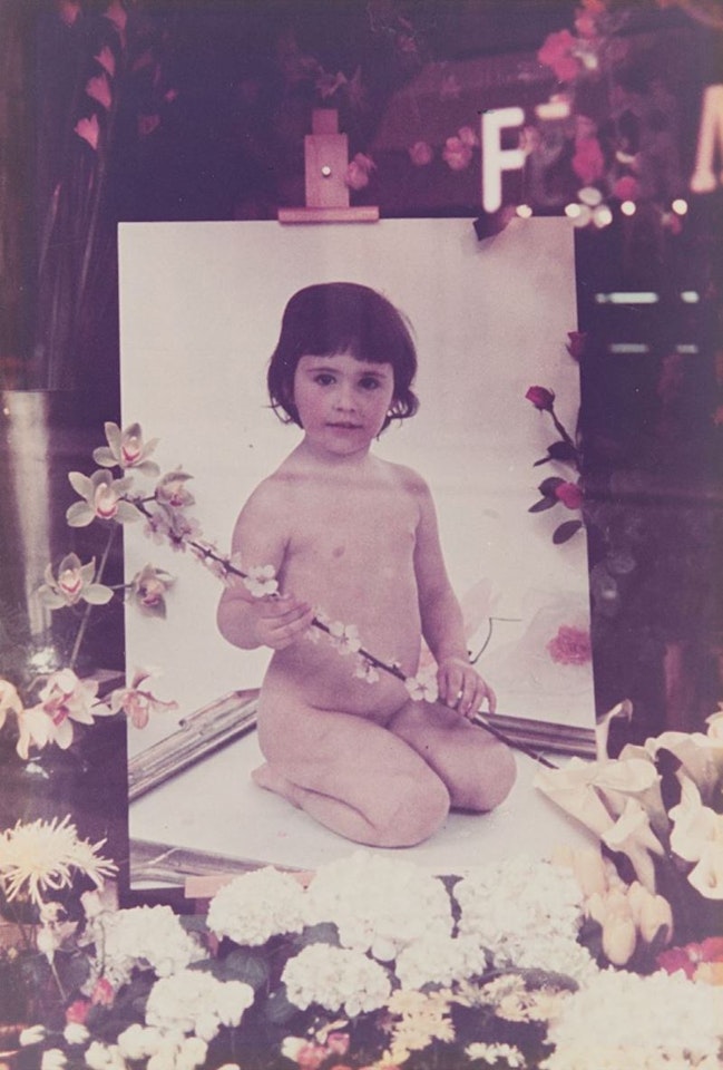 Naked little girl with flowers, Reggio Emilia by Luigi Ghirri