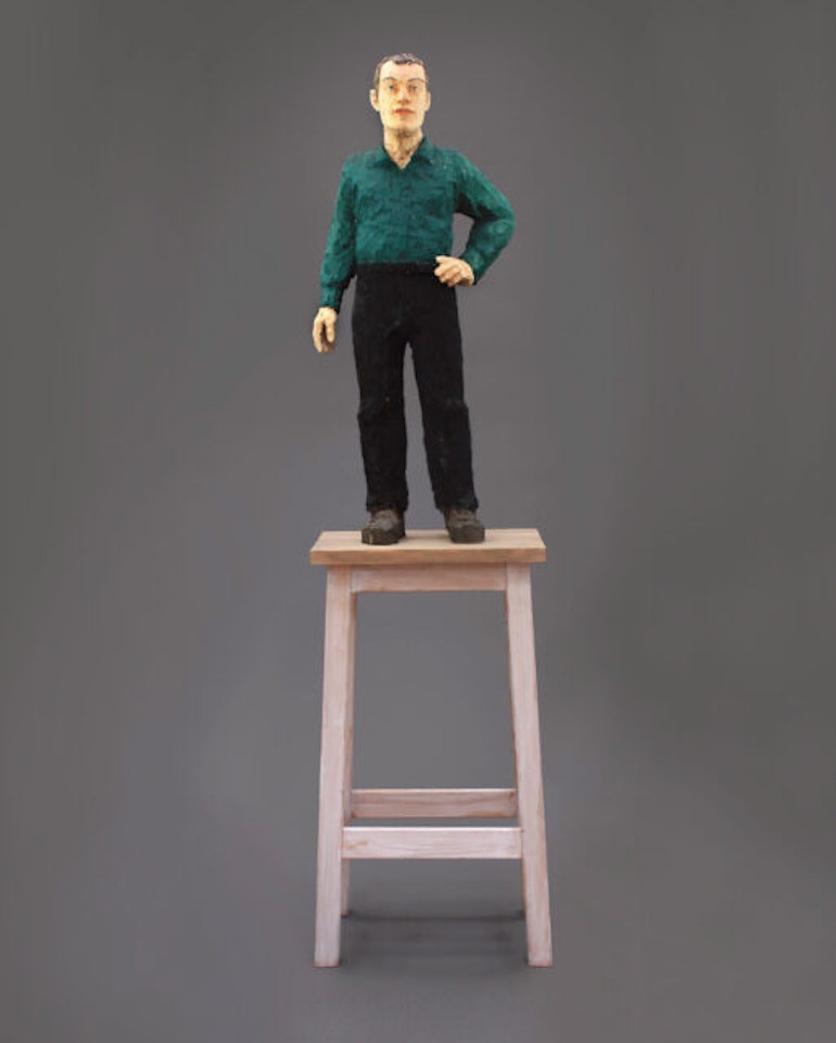 Man wearing a green shirt and black pants by Stephan Balkenhol