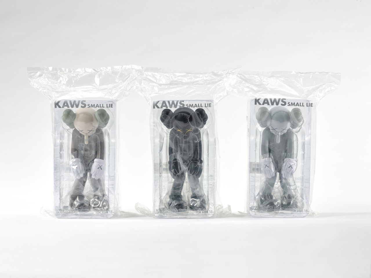 Small lies (brown; black; and grey) by Kaws