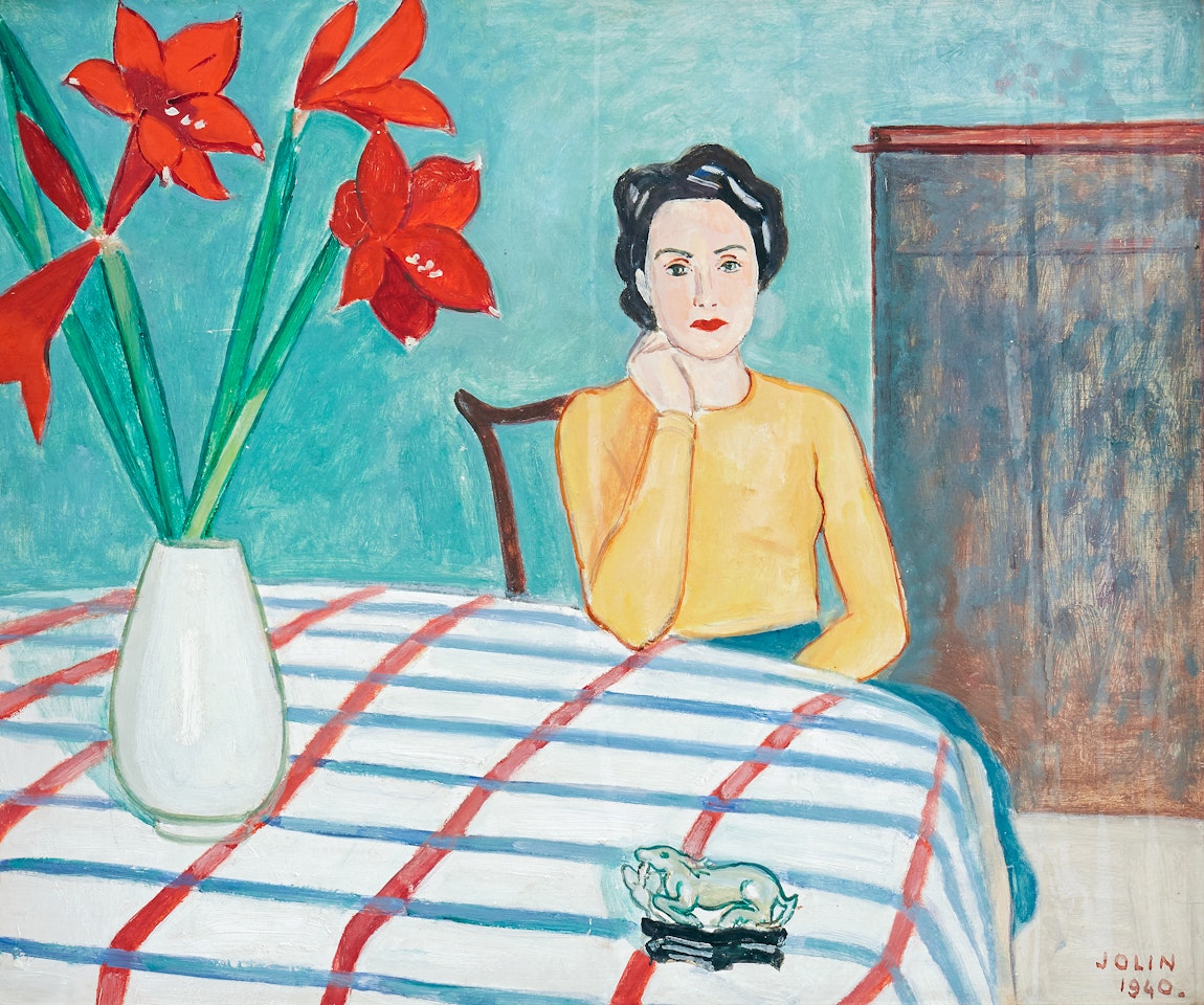 Clo sitting at table with amaryllis in vase by Einar Jolin