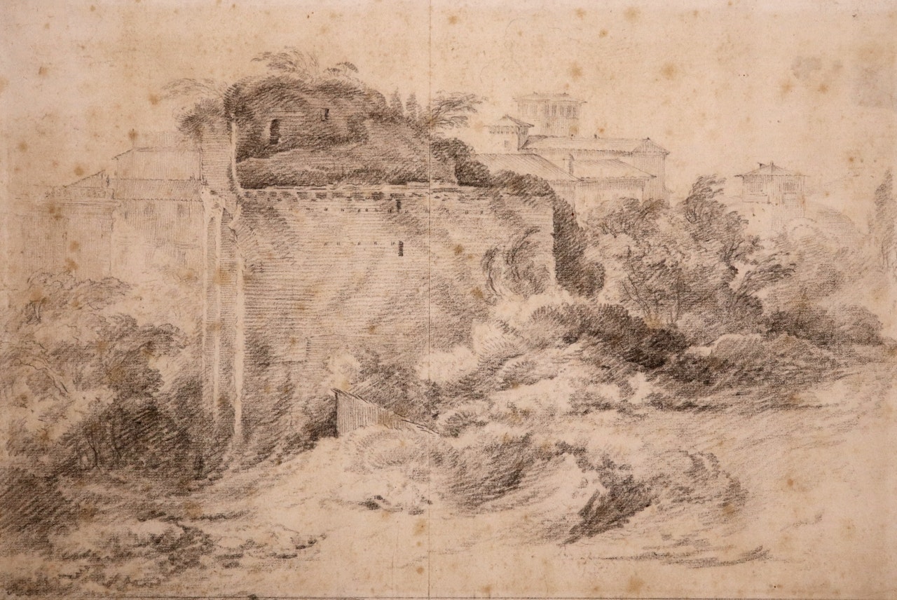 A ruin with an Italianate town beyond by English School