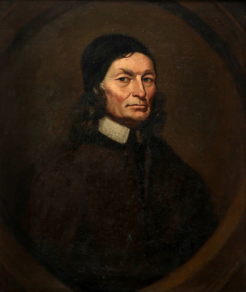 Portrait of a gentleman wearing a brown coat, lace collar and black cap, in a painted oval by English School