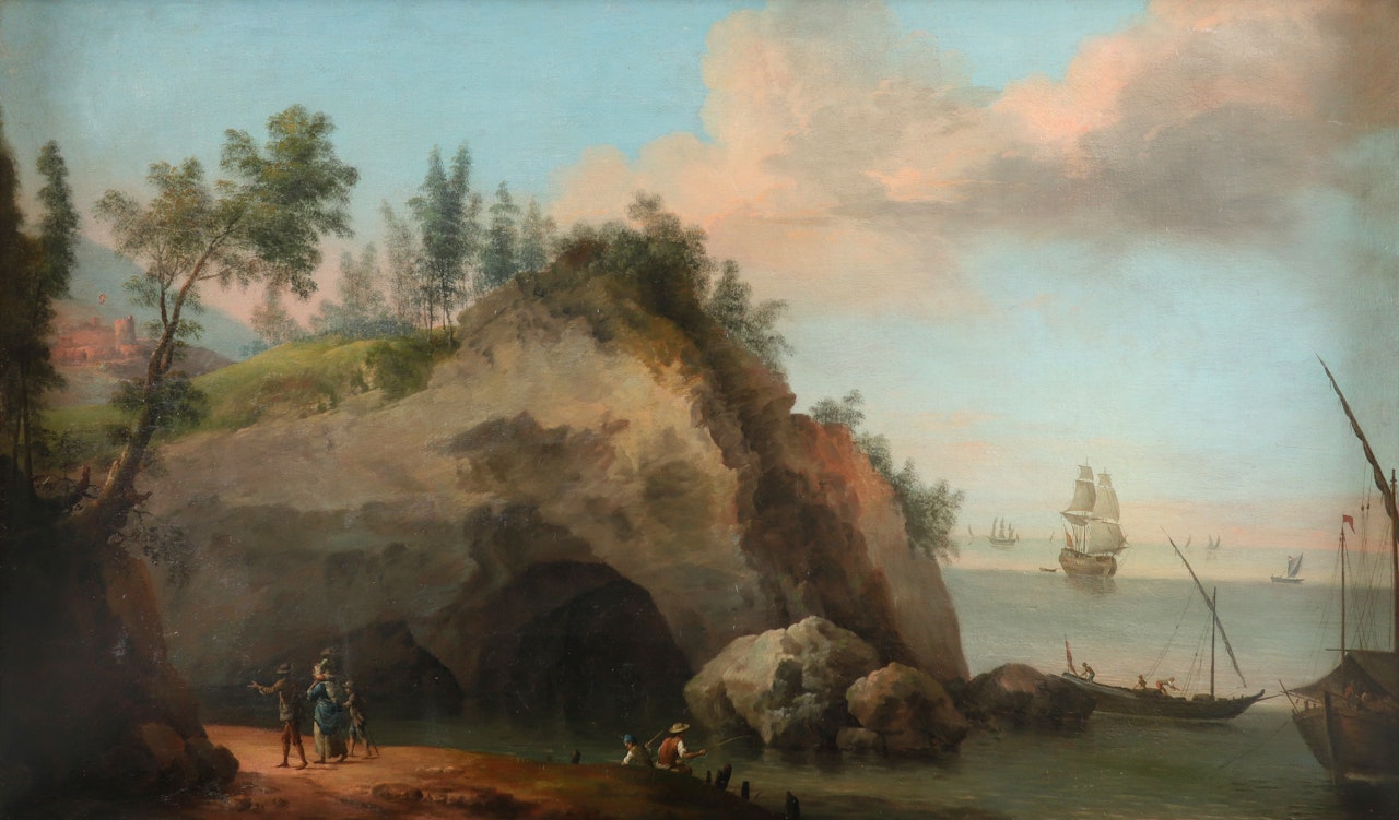Coastal landscape with fishermen and travellers on a path across the water from a cave, with shipping beyond by English School