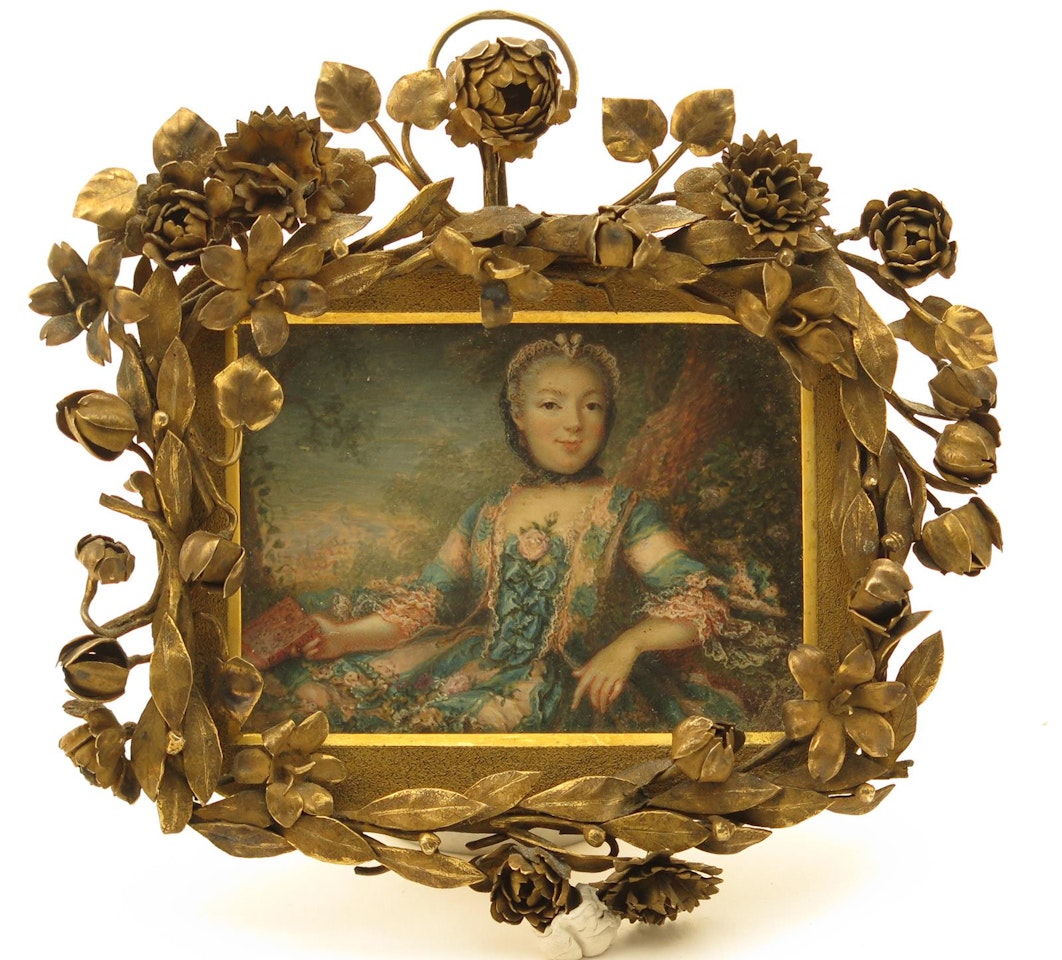Portrait miniature of a lady seated by a tree in a landscape holding a book by French School