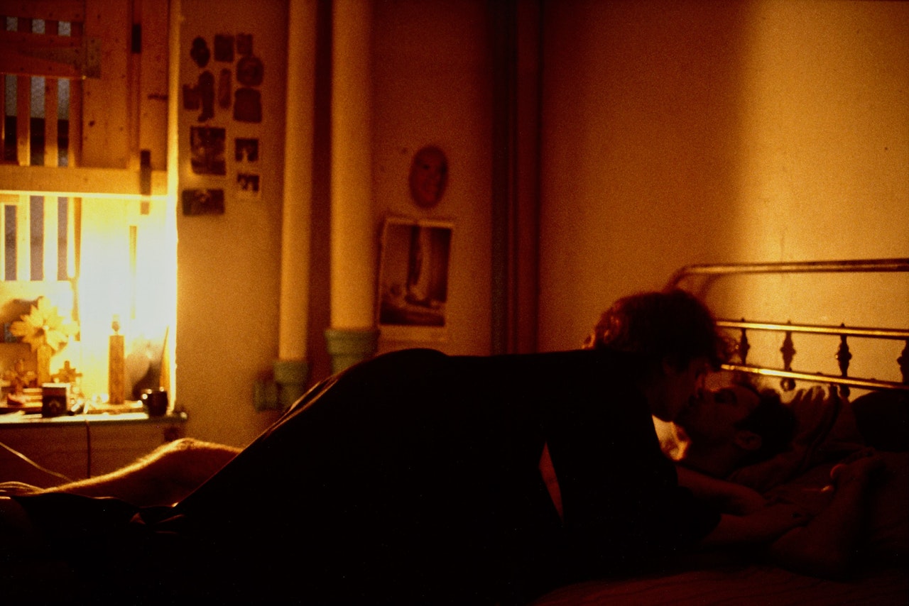 Self-portrait on top of Brian; Kissing, NYC by Nan Goldin