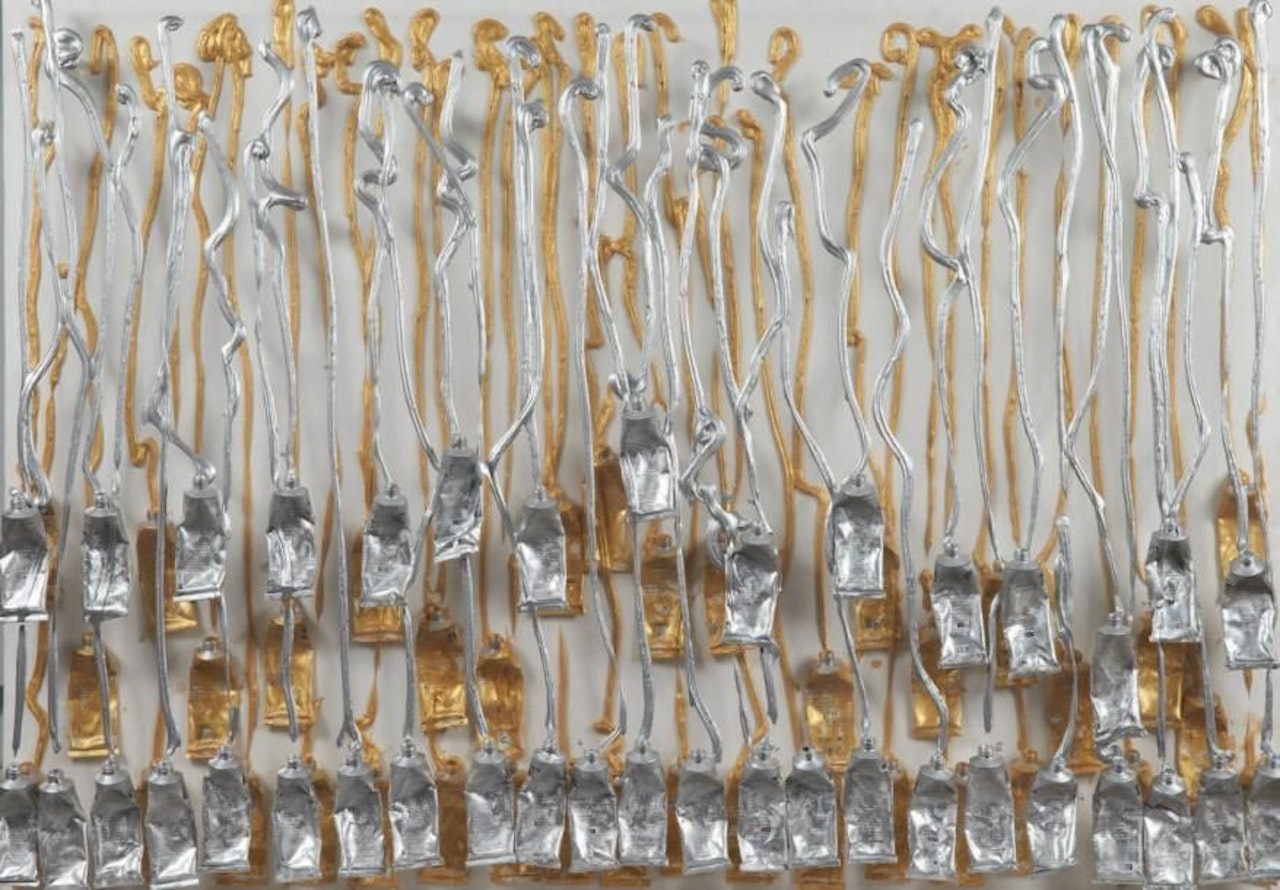 Silver and gold tubes by Arman