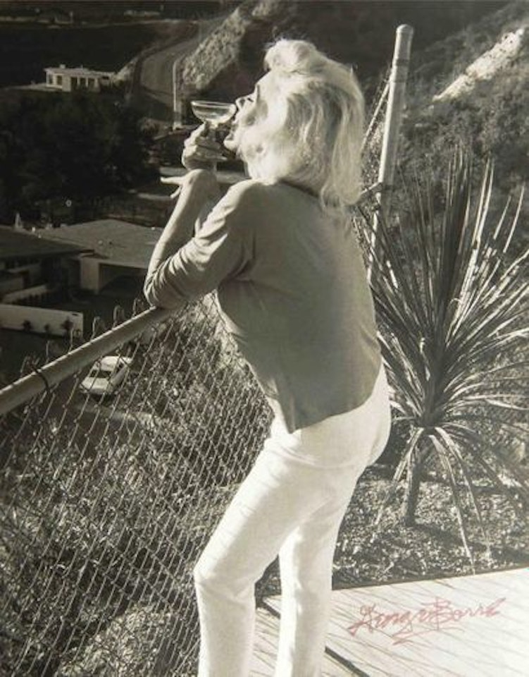Marilyn Monroe with a glass of champagne by George Barris