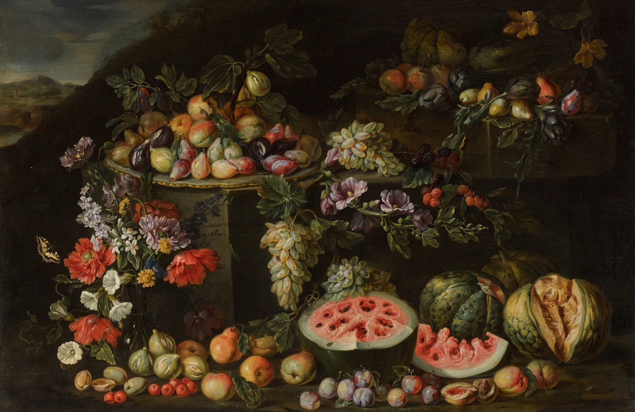 Still life of flowers in a crystal vase, plums, peaches and figs on a plate, watermelons and other fruit on a rocky bank in a landscape by Roman School