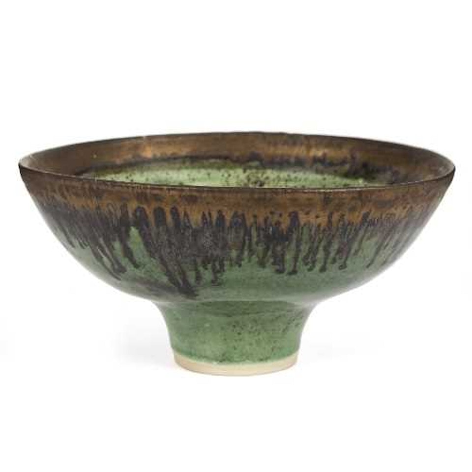 Stoneware footed bowl with an emerald green glaze and bronzed manganese drip rim by Lucie Rie