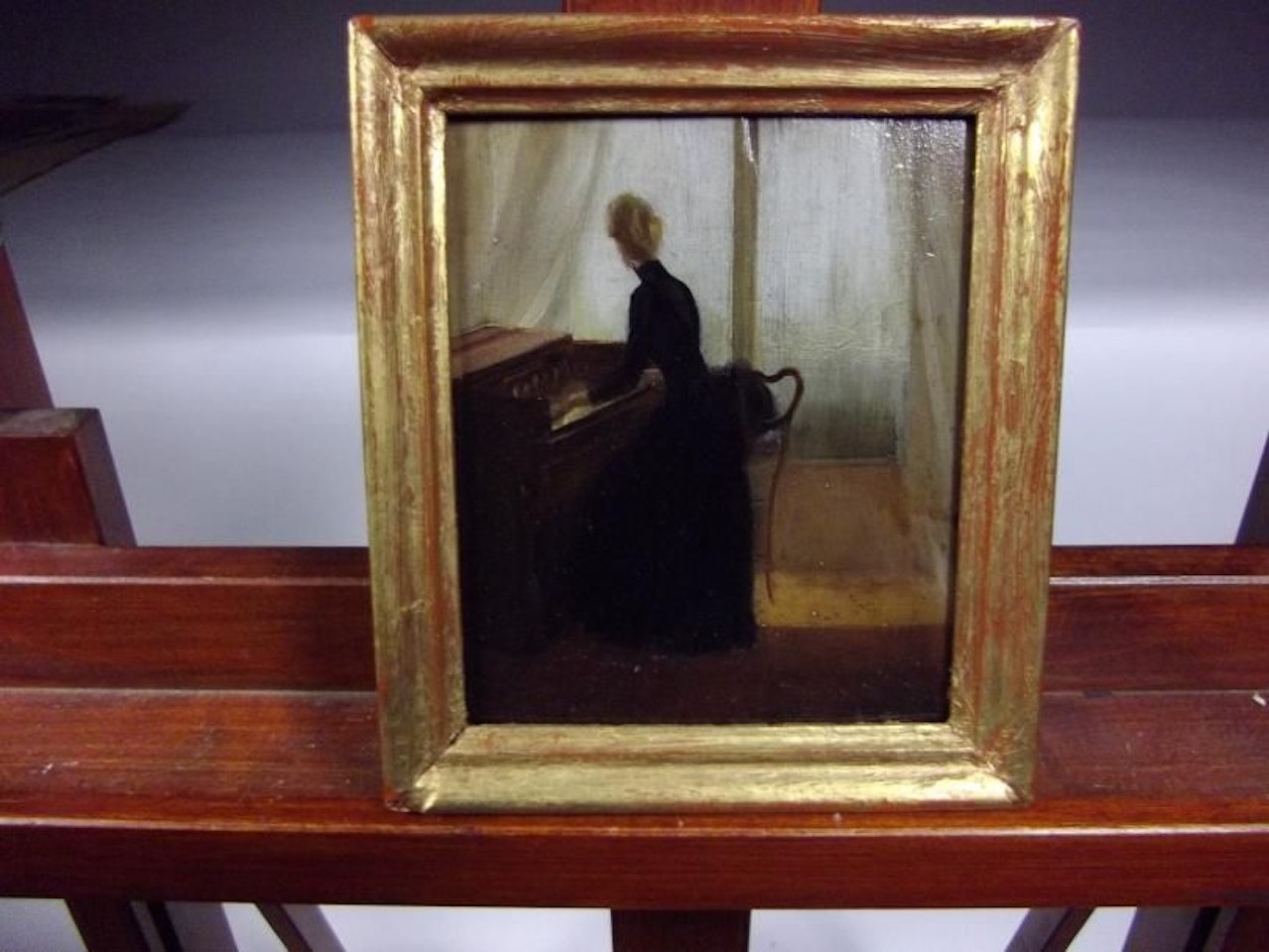 Young woman playing the harmonium by French School