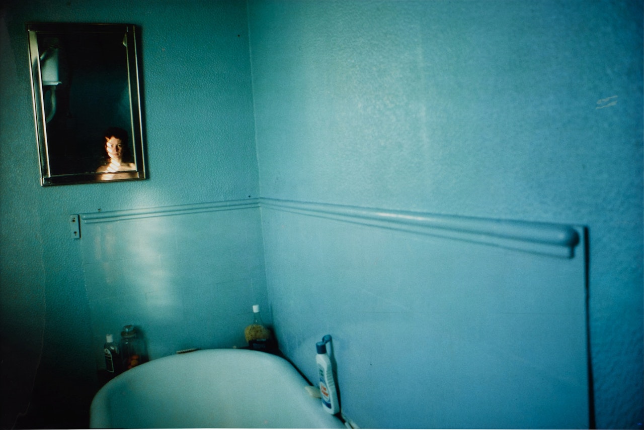 Self-portrait in blue bathroom, London by Nan Goldin